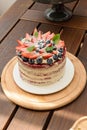 Red velvet cake on a wooden table with basil leaves to decorate vertical photo. Royalty Free Stock Photo