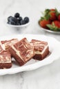 Red Velvet Cream Cheese Brownies on White Ceramic Plate