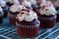 Red velvet cup cakes on cooling rack