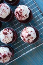 Red velvet cup cakes on cooling rack