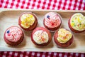 Red velvet cup cakes with white and rose topping Royalty Free Stock Photo