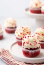 Red velvet cupcake with cream cheese frosting and red hearts sprinkles on the top. Valentine\'s Day concept. Royalty Free Stock Photo