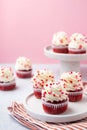 Red velvet cupcake with cream cheese frosting and red hearts sprinkles on the top. Valentine\'s Day concept. Royalty Free Stock Photo