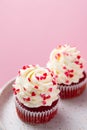 Red velvet cupcake with cream cheese frosting and red hearts sprinkles on the top. Valentine\'s Day concept. Royalty Free Stock Photo