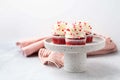 Red velvet cupcake with cream cheese frosting and red hearts sprinkles on the top. Valentine's Day concept. Royalty Free Stock Photo