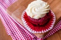 Red Velvet Cupcake with cream on wooden surface. Royalty Free Stock Photo