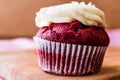 Red Velvet Cupcake with cream on wooden surface. Royalty Free Stock Photo