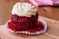 Red Velvet Cupcake with cream on wooden surface. Royalty Free Stock Photo