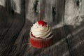 Red velvet cupcake decorated with vanilla cream on