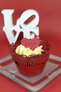 Red velvet cupcake with vanilla frosting and cute red hearts with love message Royalty Free Stock Photo