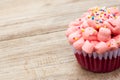 Red velvet cupcake on wood background. Royalty Free Stock Photo