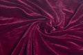 Red velvet fabric with spiral folds Royalty Free Stock Photo