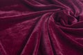 Red velvet fabric with spiral folds Royalty Free Stock Photo