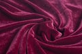 Red velvet fabric with spiral folds Royalty Free Stock Photo