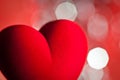 Red velvet heart, defocused lights on background Royalty Free Stock Photo