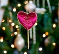 Red velvet heart in front of xmas tree Royalty Free Stock Photo