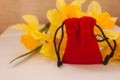 Red velvet pouch with yellow flowers on a white background, copy space Royalty Free Stock Photo