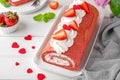 Red velvet rolled cake with fresh strawberries and cream cheese. Valentine`s Day dessert. Selective focus Royalty Free Stock Photo