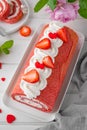 Red velvet rolled cake with fresh strawberries and cream cheese. Valentine`s Day dessert. Selective focus Royalty Free Stock Photo