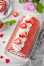 Red velvet rolled cake with fresh strawberries and cream cheese. Valentine`s Day dessert. Selective focus. Royalty Free Stock Photo