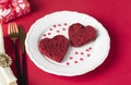 Red velvet sponge cakes in the shape of hearts on white plate Royalty Free Stock Photo