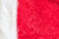 Red velvet texture background and white soft fluffy  fur part of Christmas Santa Claus fashion clothing costume and hat accessory Royalty Free Stock Photo