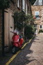 Red Vespa motorbike parked by a house in Dunworth Mews, Notting Royalty Free Stock Photo