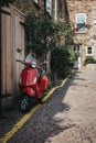 Red Vespa motorbike parked by a house in Dunworth Mews, Notting Royalty Free Stock Photo