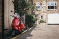 Red Vespa motorbike parked by a house in Dunworth Mews, Notting Royalty Free Stock Photo