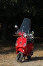 A red Vespa moped parked