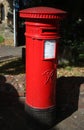 Red Victorian pillar box on street, York