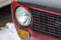 Red vintage car on a festival of old cars. Retro car& x27;s headlight close up. Royalty Free Stock Photo