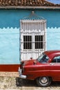 Red vintage car in the old center of Trinidad, Cuba Royalty Free Stock Photo