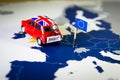 Red vintage car with Union Jack flag and brexit or bye words over an UE map and flag. Royalty Free Stock Photo