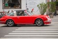 Red vintage coupe Porsche 911 (964) at the crossroads with a powerful engine