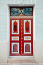 Red vintage door on a old building facade in old Tallinn city