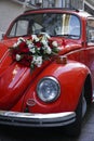 A red vintage German Car is decorated with flowers as a wedding car Royalty Free Stock Photo