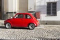 Red vintage italian car parked in the city center Royalty Free Stock Photo