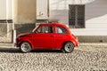 Red vintage italian car parked in the city center Royalty Free Stock Photo