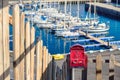 Red vintage mailbox in front of the idyllic harbor of Puerto de la Estaca