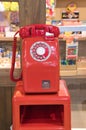 A red vintage payphone setting as display. Royalty Free Stock Photo