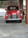 Red vintage pick up under carport for local grocery business Royalty Free Stock Photo
