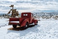 Red vintage pickup truck in snow in California high desert