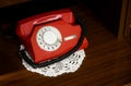 Red vintage telephone with a phone on the table Royalty Free Stock Photo