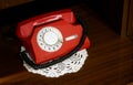 Red vintage telephone with a phone on the table Royalty Free Stock Photo