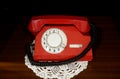 Red vintage telephone with a phone on the table Royalty Free Stock Photo