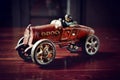 Red vintage toy car on dark wooden table Royalty Free Stock Photo