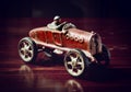 Red vintage toy car on dark wooden table Royalty Free Stock Photo