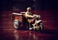 Red vintage toy byke on dark wooden table Royalty Free Stock Photo