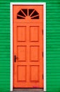 Red vintage wooden door and green wall Royalty Free Stock Photo